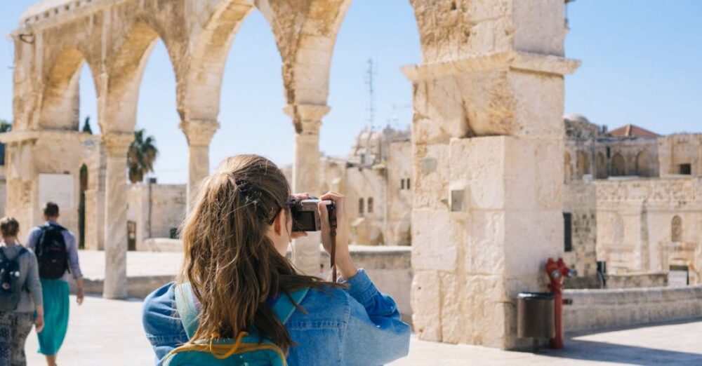 Tourists - Woman Taking Pictures of Ruins
