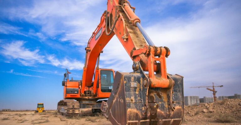 Equipment - Low Angle Photography of Orange Excavator Under White Clouds