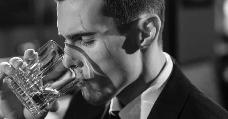 Threats - Monochrome Photo of Man Drinking Whiskey